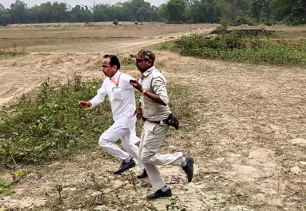 Dakshin Dinajpur BJP candidate Suvendu Sarkar runs off with a security official after being allegedly manhandled while heading to a polling booth
