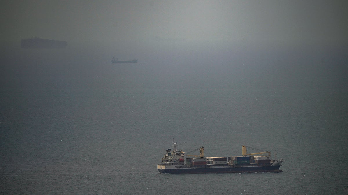 A cargo ship sails in the Persian Gulf toward the Strait of Hormuz, 22 April