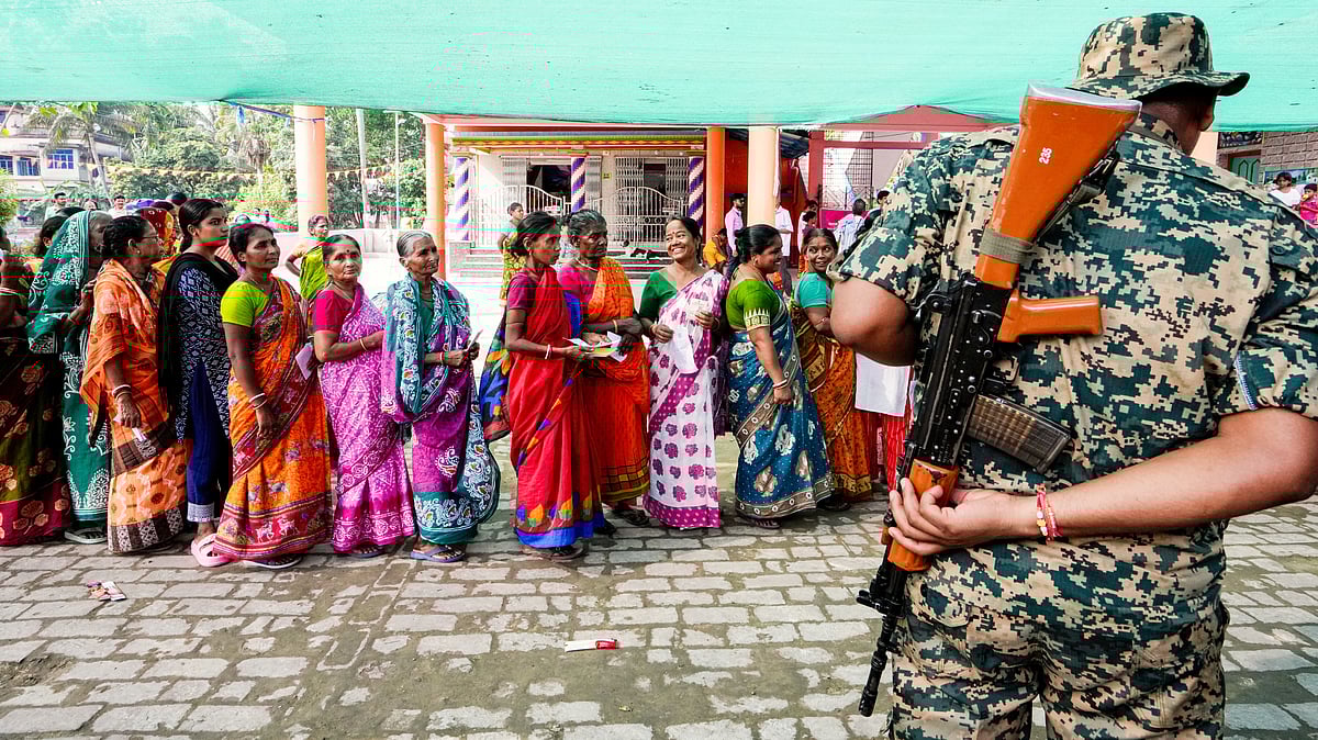 Voters queue under a makeshift shade to escape the heat in Panskura, East Midnapore district, 23 April