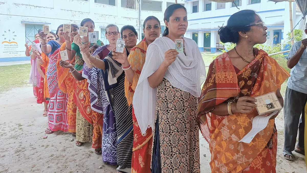 Women queue up to vote, brandishing their voter ID cards in Murshidabad, West Bengal 