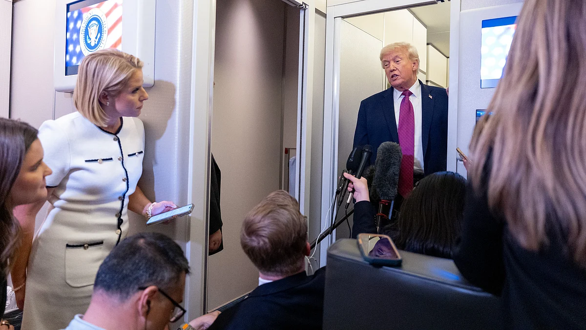 Trump speaks to reporters aboard Air Force One.
