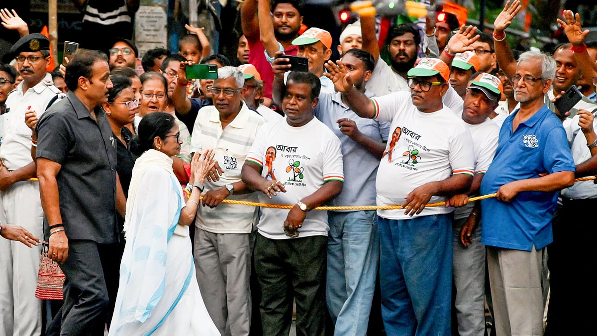 Mamata Banerjee during a roadshow ahead of phase two of the Assembly elections, in Kolkata, 24 April