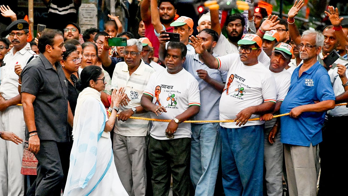 Mamata Banerjee during a roadshow ahead of phase two of the Assembly elections, in Kolkata, 24 April
