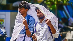 Two men cover themselves to stay protected from the heat