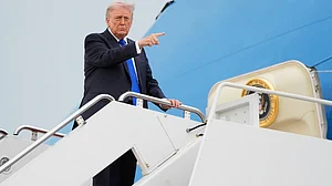 Donald Trump gestures while boarding Air Force One at Joint Base Andrews, Maryland.