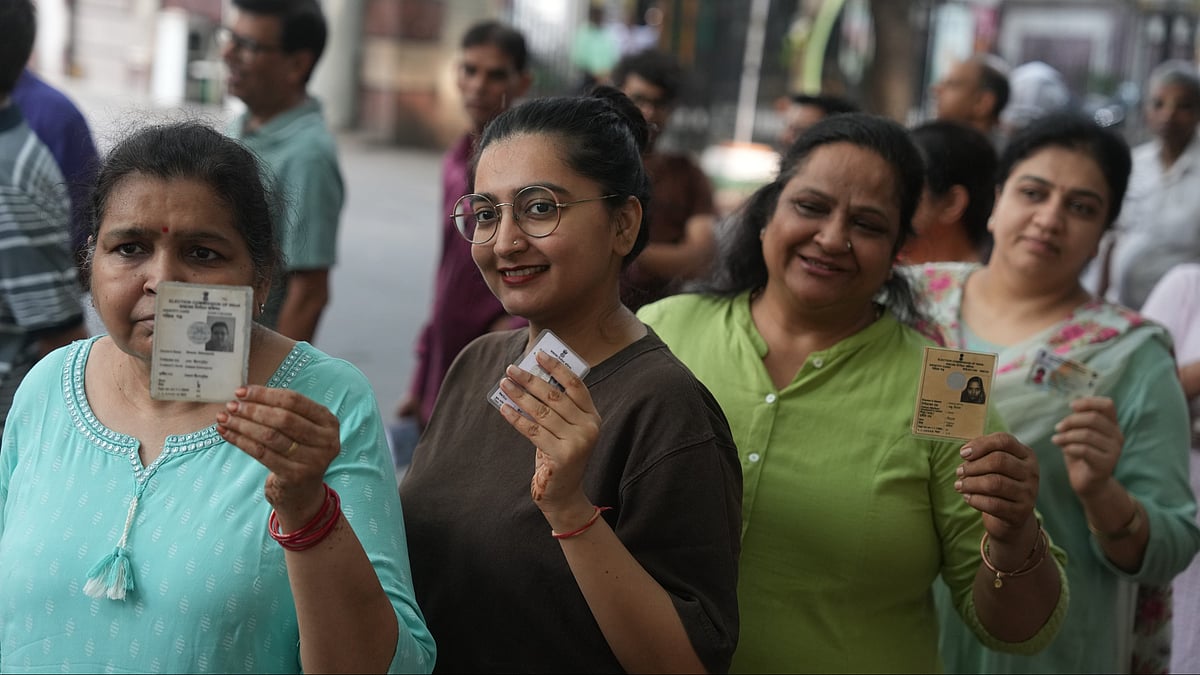 Voters display ID cards while queuing to cast their ballots in Kolkata.