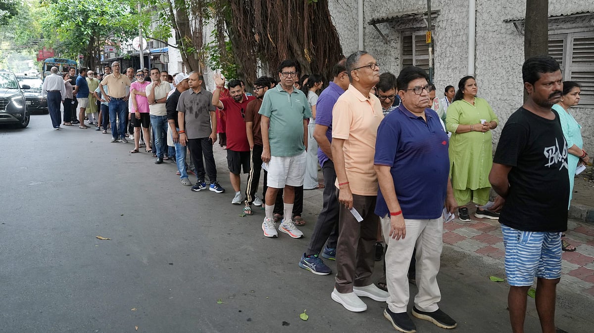 Voters queue up to cast their ballots during phase II of the West Bengal assembly elections in Kolkata.