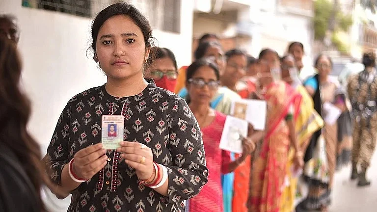 Voters line up to vote at a polling station in Kolkata