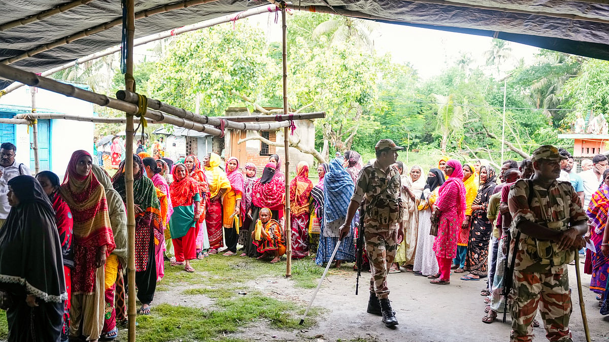 Security personnel stand guard over voters at Magrahat Paschim, South 24 Parganas, 2 May