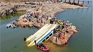 Rescue personnel recover the cruise boat that overturned in Bargi dam due to a sudden storm