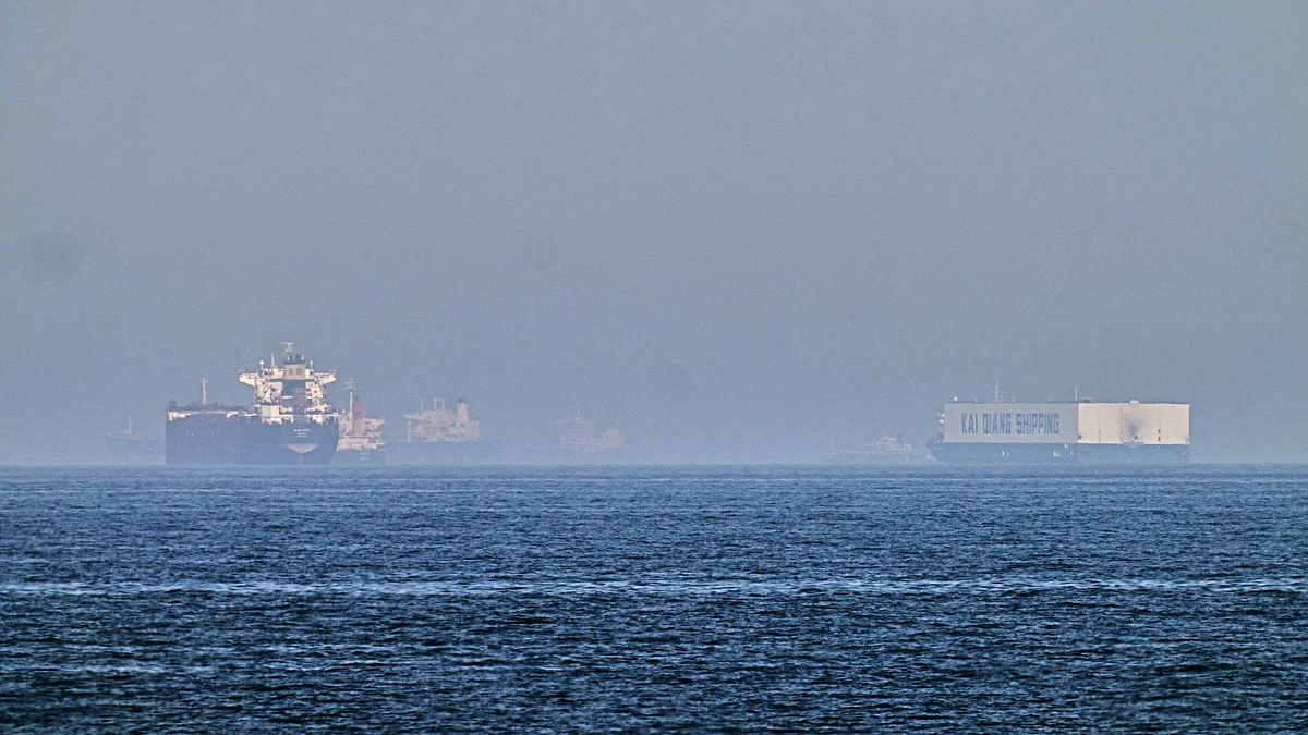 A tanker, left, and a car carrier are anchored at sea in Gulf of Oman near Strait of Hormuz.