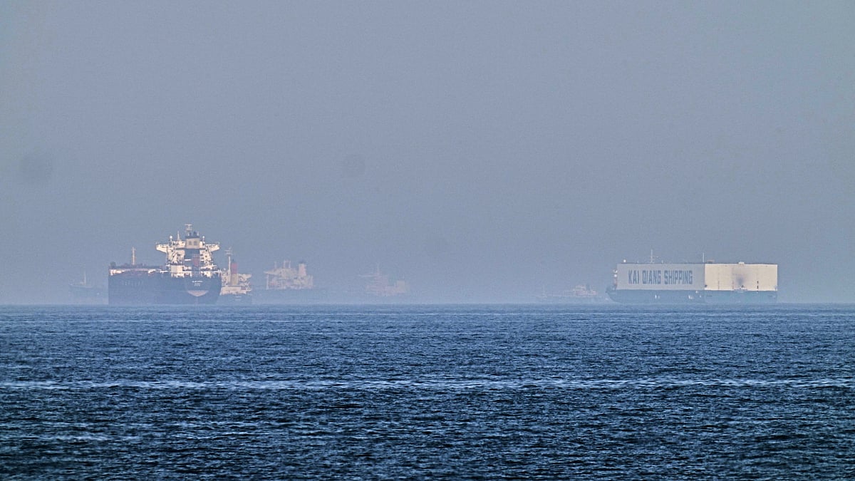 A tanker, left, and a car carrier are anchored at sea in Gulf of Oman near Strait of Hormuz.