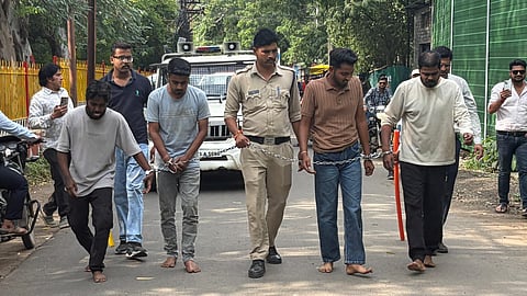 Police Take Four Accused to Crime Scene