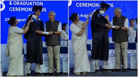 A graduate carried his pet cat on his shoulder while receiving his degree.