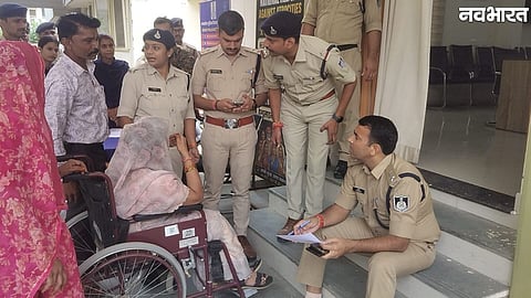 Morena SP Dharamraj Meena sits on stairs to hear complainant