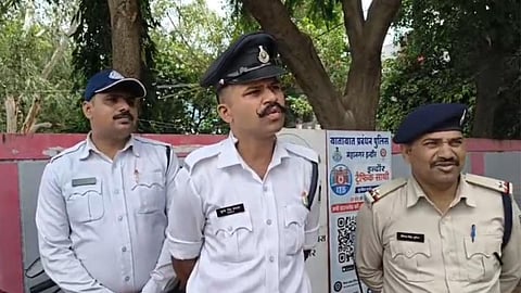Traffic police personnel helping a woman injured in a blade attack.