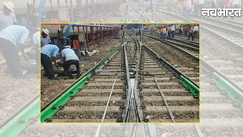 Railway employees carrying out track modernization work at the Pune railway yard