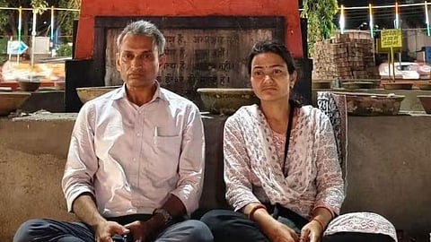 Social worker Prahlad Pandey sitting on an indefinite protest with his wife under Gandhi statue in Indore