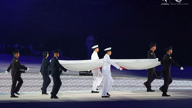 Military honor guard with Japanese national flag across the arena