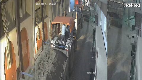 Illegal sand-filled tractor trolleys speeding through a narrow street in Morena
