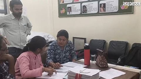 BA first-year students inspect their answer sheets at Excellence Girls College in Sagar