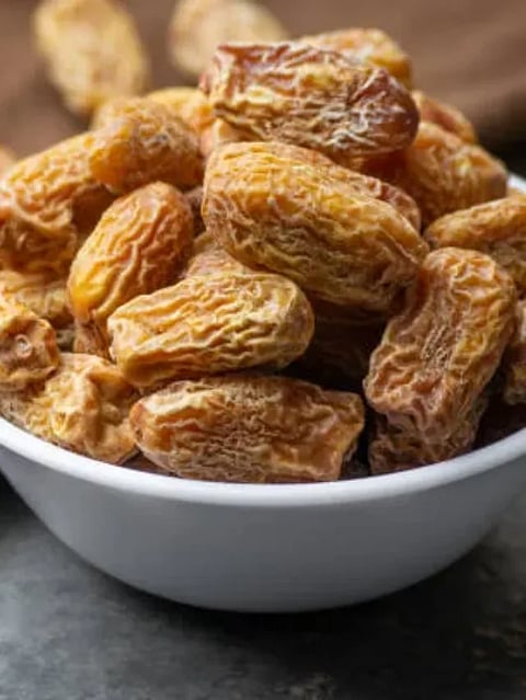 Indian dry dates in white bowl