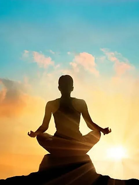 women meditating pastel on high mountain in sunset background