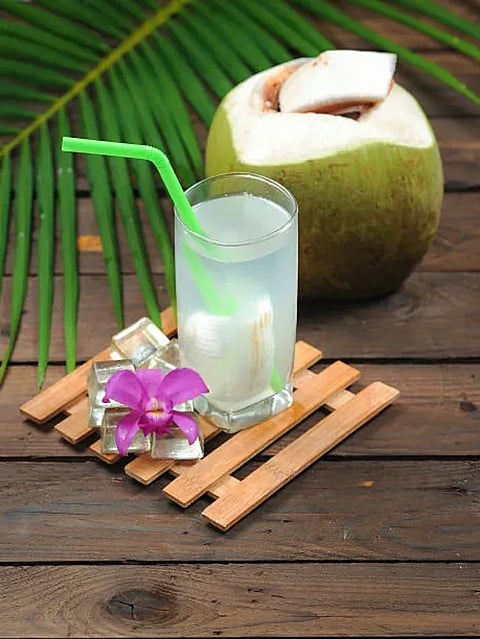 Fresh Coconut Water Drink on wood