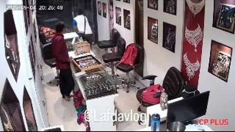 A viral video shows a jewellery theft where the servant remains busy on a phone call while the thief escapes with ease.