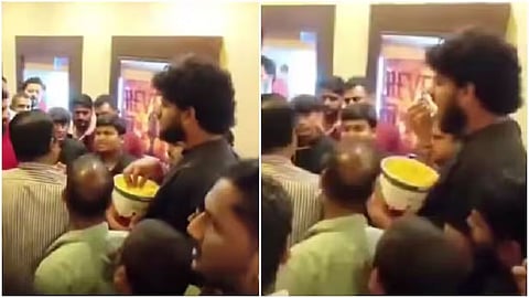 A man calmly eating popcorn amid a fan fight has gone viral online.