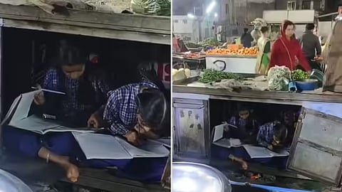 A viral video shows two girls studying under their father’s vegetable cart, inspiring many online.