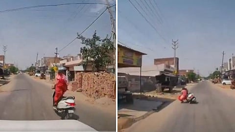 A girl fell from her scooty after crossing a speed breaker, and the dashcam video went viral.