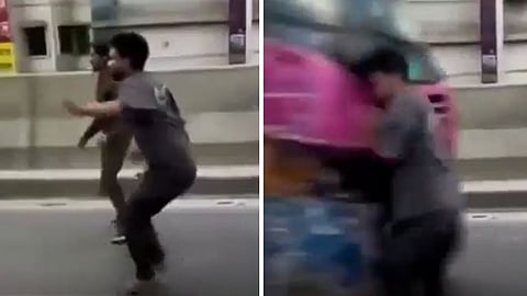 A viral video shows a young man being hit by a bus after standing in the middle of a busy road, sparking road safety concerns.