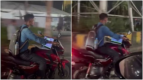 A man working on a laptop while riding a motorcycle in Telangana sparked concern and criticism online.