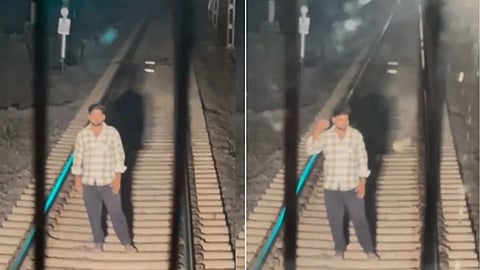 A video of a man standing on a railway track and stopping a train has gone viral on social media.