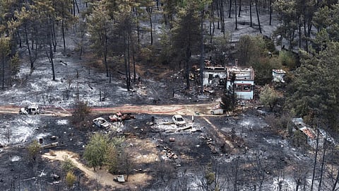 Out-of-control fires wreak havoc in Greece; father and son die tragically; evacuation orders issued for several areas.