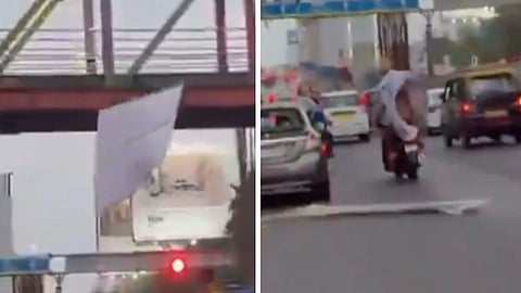A viral video showing a banner falling from a foot overbridge onto bike riders has reignited concerns over public safety and roadside hoardings.