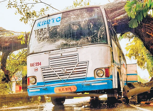A KSRTC bus lying abandoned at Fort Kochi after a tree fell on it following strong wind | Express