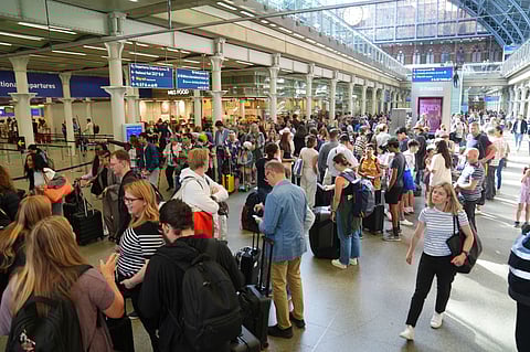Passengers queue at the Eurostar terminal at St. Pancras station in central London, Friday July 26, 2024. Hours away from the grand opening ceremony of the Olympics, high-speed rail traffic to the French capital was severely disrupted on Friday by what officials described as “criminal actions” and sabotage. 
