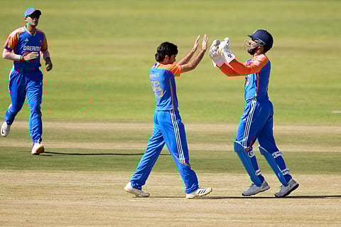 Ravi Bishnoi celebrates after taking a wicket.