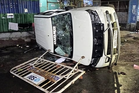 A vandalised Kolkata Police vehicle is seen amid protest at the RG Kar Medical College and Hospital against the alleged rape and murder of a trainee doctor inside the hospital premises, in Kolkata, early Thursday, Aug. 15