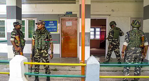 Security personnel stand guard at a polling station ahead of the 1st phase of Jammu and Kashmir Assembly elections, at Pampore area in Pulwama district of South Kashmir, Tuesday, Sept. 17, 2024.