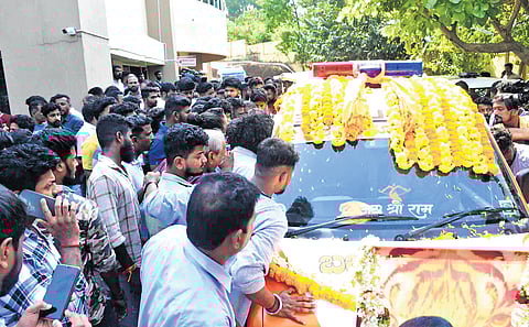 People gather around the ambulance carrying the body of Hindu activist Suhas Shetty outside a hospital in Mangaluru on Friday.