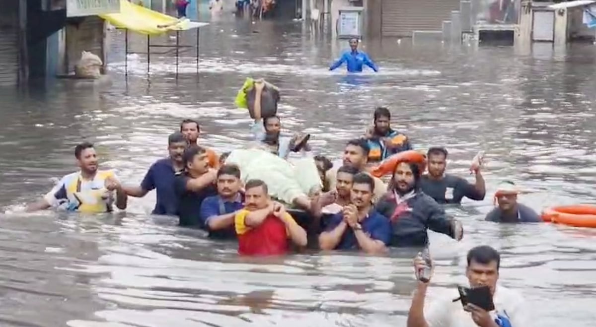 Surat floods paralyze rescue; heart patient stranded; life endangered.