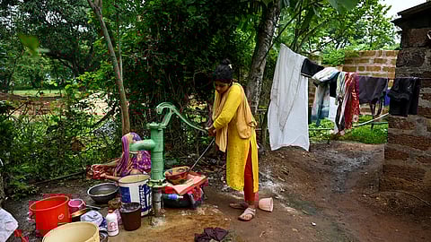Lopamudra Bal, daughter of Urmila Bal, who died of diarrhoea, collecting water from a tubewell in Suanri Village under Dharmasala block of Jajpur district. 