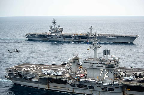 The USS Ronald Reagan and USS Abraham Lincoln sailed in formation during dual-carrier operations in the Pacific, May 20, 2022.
