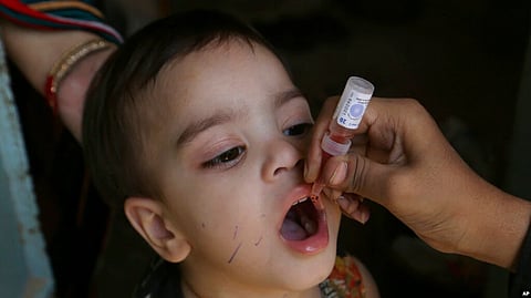 A health worker administers a polio vaccine to a child in Karachi, Pakistan, Sept. 20, 2021. In 1979, polio was declared eliminated in the U.S., meaning there was no longer routine spread. Rarely, travelers have brought polio infections into the U.S.