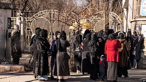 Afghan female university students are stopped by Taliban security personnel next to a university in Kabul, Dec. 21, 2022. (AFP)