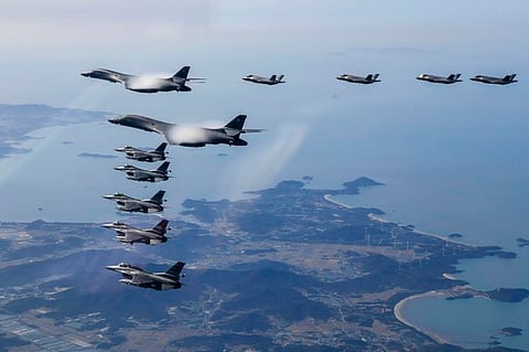 Two U.S. Air Force B-1B bombers [top left], South Korean Air Force F-35 fighter jets [right], and U.S. Air Force F-16 fighter jets [bottom left] fly over the South Korean Peninsula during a joint air drill, Nov. 19, 2022 (AFP/South Korean Defense Ministry)