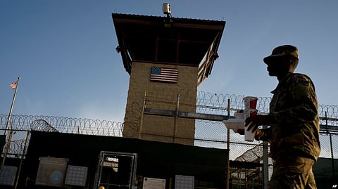 FILE - In this June 5, 2018 photo, reviewed by U.S. military officials, a task force member walks past the Camp 6 detention facility at the Guantanamo Bay U.S. Naval Base, Cuba. (AP)